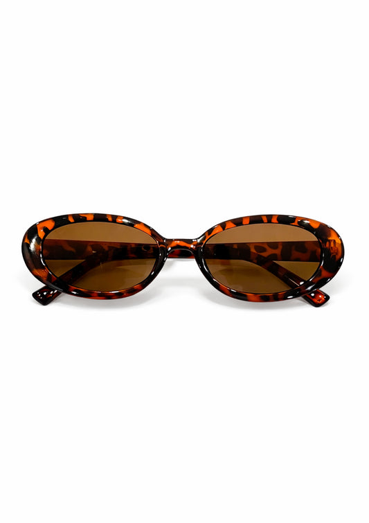Animal print sunglasses with brown lenses on a white background