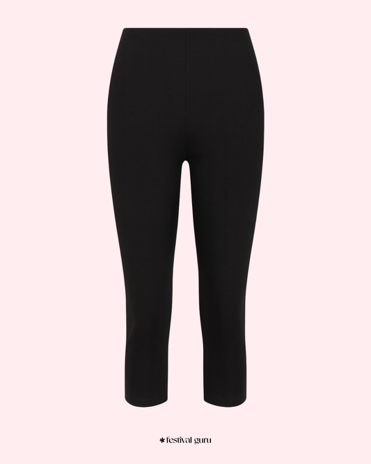 Black leggings on a light pink background