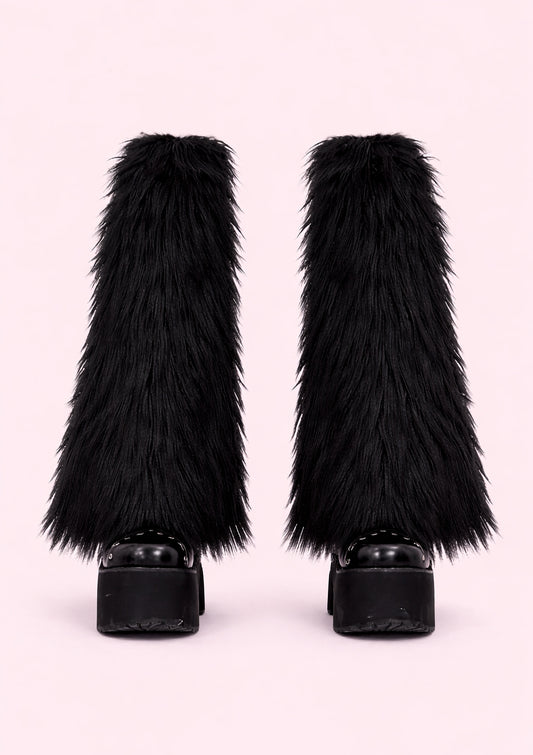 Black furry leg warmers on a light pink background