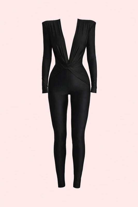 Black jumpsuit on a light pink background