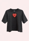 Заредете изображението в програмата за преглед на галерия, Black t-shirt with a red heart-shaped patch on a light pink background