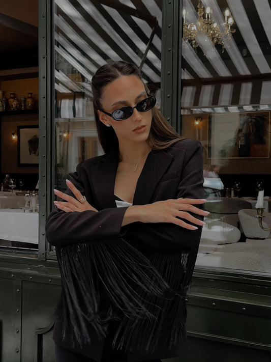 Woman wearing sunglasses in a stylish interior setting