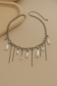 Заредете изображението в програмата за преглед на галерия, Necklace with chain and pearl-like pendants on a beige background