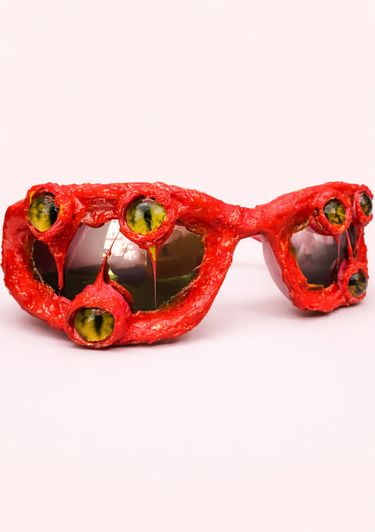 Red sunglasses with a textured frame on a white background