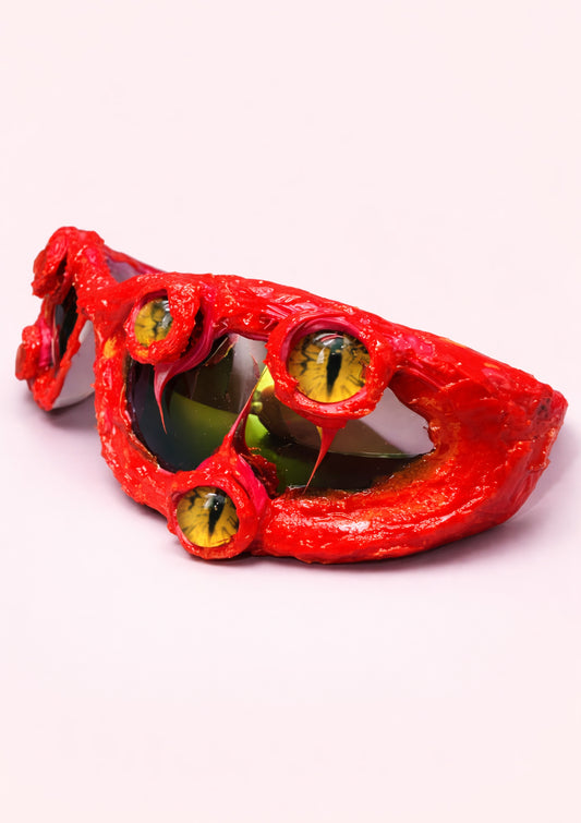 Red sunglasses with yellow lenses on a white background