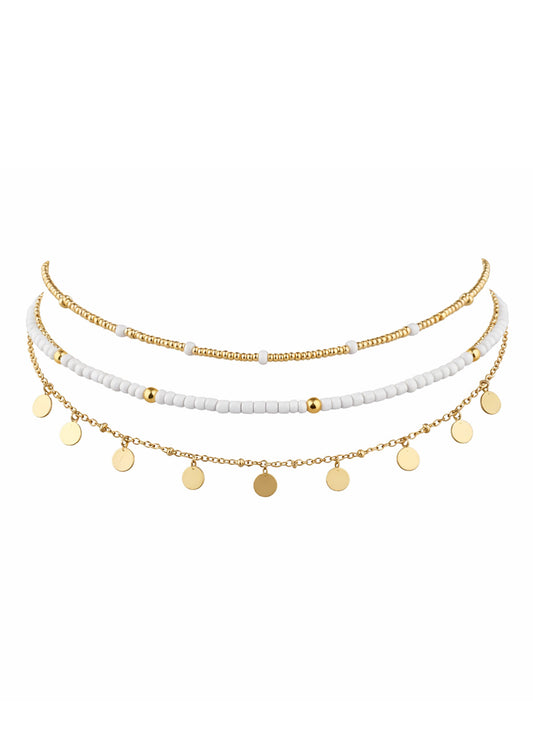 Set of three gold and white beaded necklaces on a white background