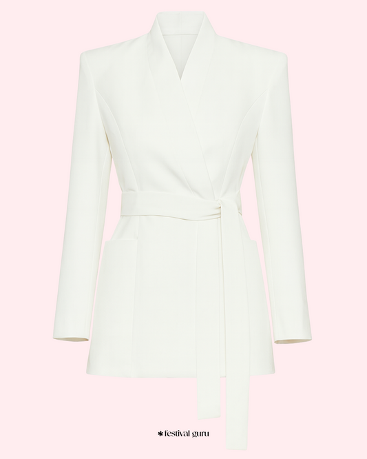 White blazer on a pink background with 'festival guru' branding.