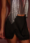 Заредете изображението в програмата за преглед на галерия, Person wearing black skirt and a silver sequin top against a dark background