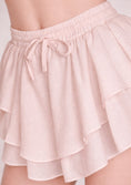 Load image into Gallery viewer, cream white ruffled shorts with a tie waist on a neutral background