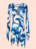 Load image into Gallery viewer, A long-sleeve sheer mesh tunic dress featuring an abstract blue, white, and navy geometric swirl pattern, displayed against a solid pale peach background.