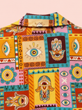 Заредете изображението в програмата за преглед на галерия, A close-up of a collared button-up shirt featuring a vibrant, multicolored patchwork print with Hamsa hands, evil eye motifs, and tribal geometric patterns in yellow, orange, teal, pink, and brown.