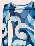 Load image into Gallery viewer, A long-sleeve sheer mesh dress featuring an abstract geometric pattern in shades of blue, navy, and white, shown against a solid pale pink background.