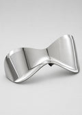Silver bow-shaped glasses 
on a light gray background