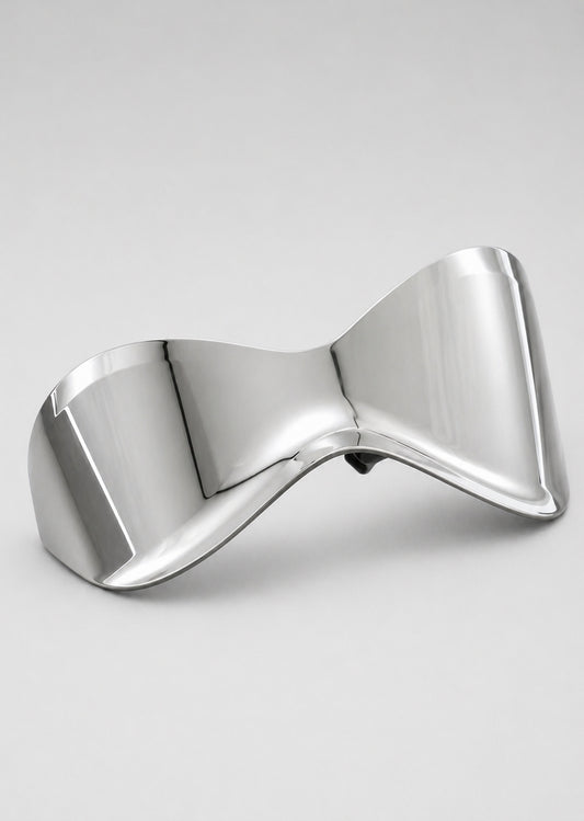 Silver bow-shaped glasses 
on a light gray background