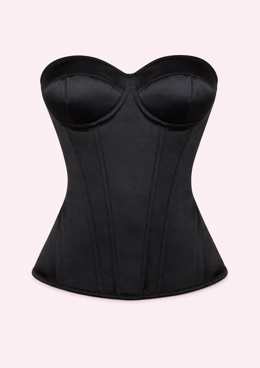Black corset on a light pink background