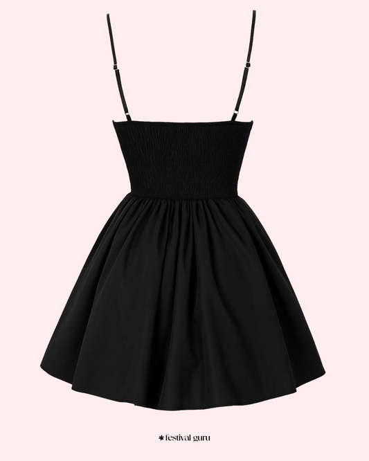 Black dress with button details on a white background