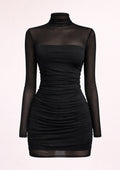 Black dress with sheer long sleeves on a light pink background