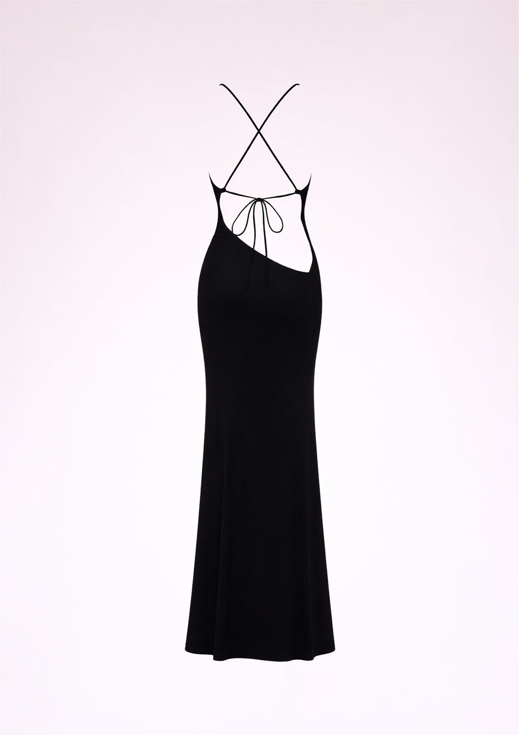 Black slip dress with thin straps on a light pink background