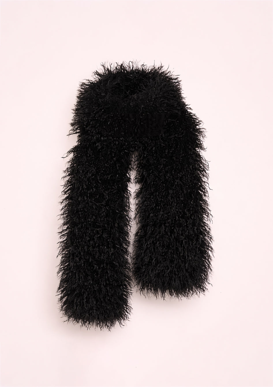 Black fluffy scarf on a light pink background