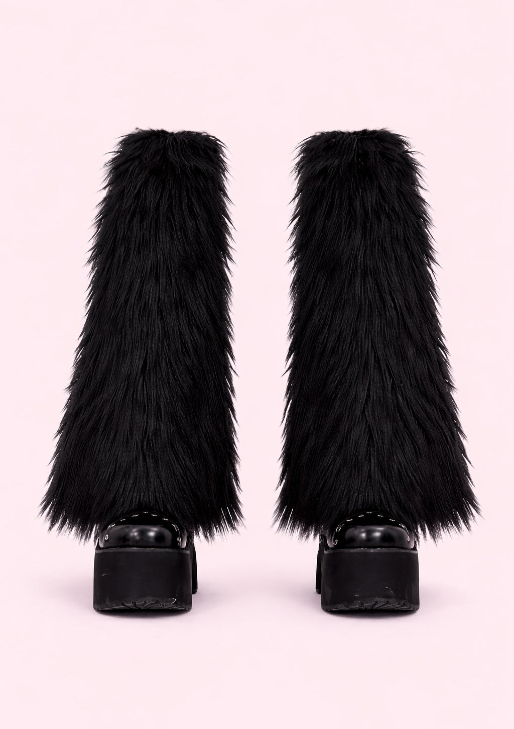 Black furry leg warmers on a light pink background