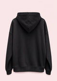 Load image into Gallery viewer, Black hoodie on a light pink background
