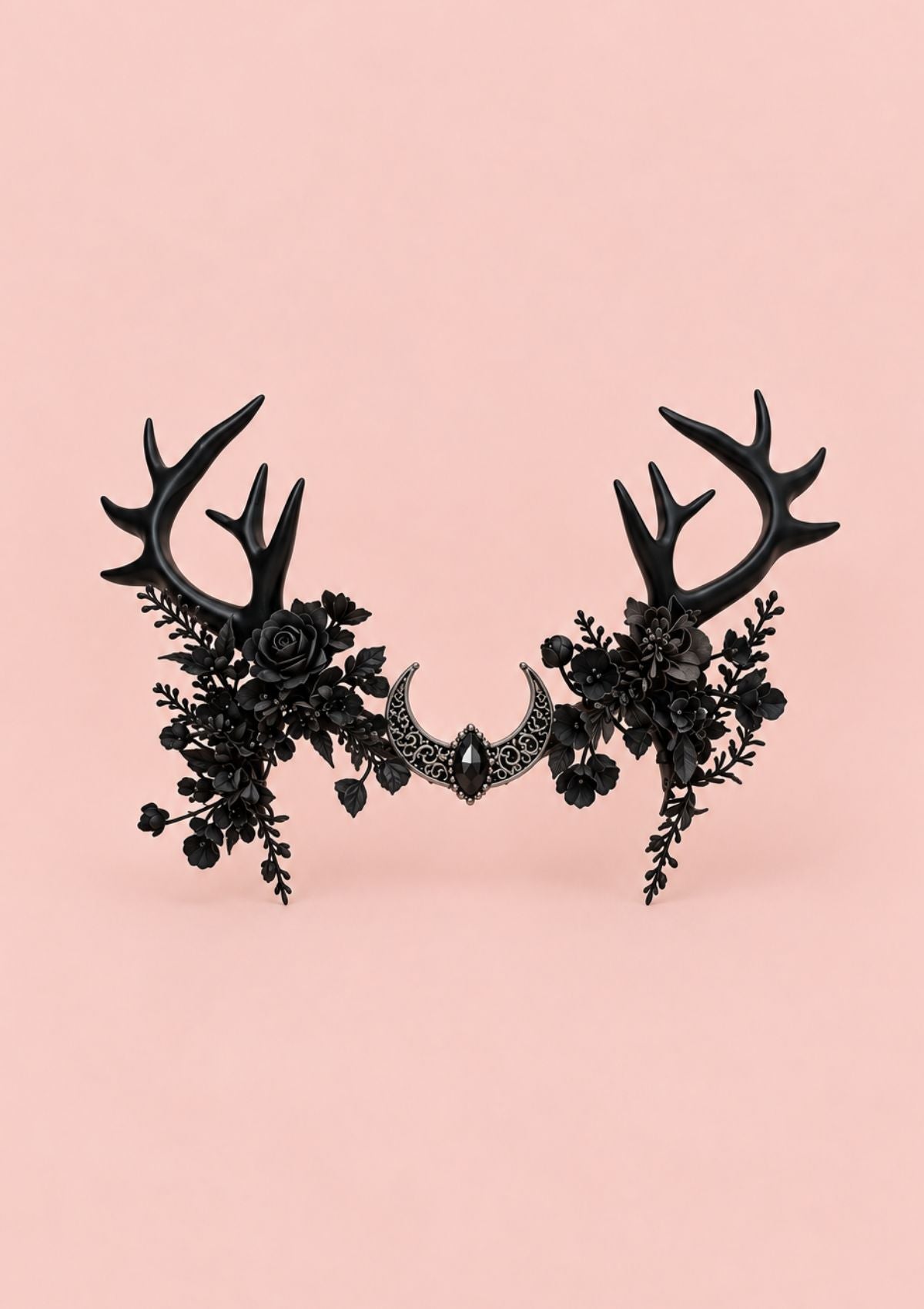 A black gothic-style antler headband decorated with black roses, leaves, and a central black crescent moon, set against a solid pale pink background.