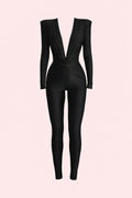 Black jumpsuit on a light pink background