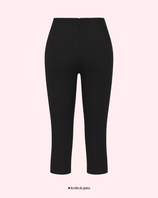 Black pants on a light pink background