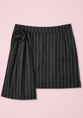 Black pinstripe skirt with a flower detail on a pink background