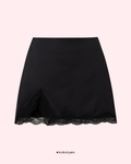 Black lace-trimmed skirt on a light pink background