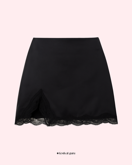 Black lace-trimmed skirt on a light pink background