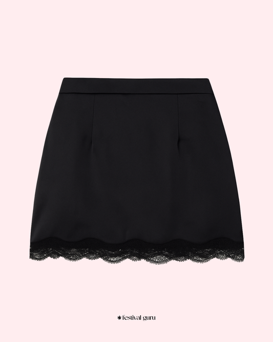 Black skirt with lace hem on a light pink background