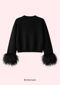 Load image into Gallery viewer, Black sweater with feathered cuffs on a pink background, featuring 'festival guru' branding.
