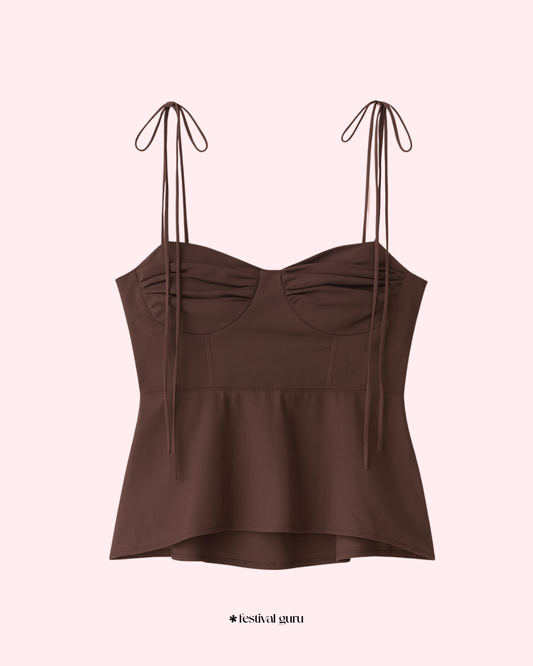 Brown strapless top with tied straps on a light pink background