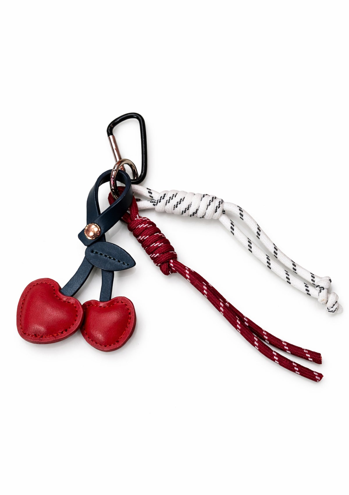 Add a playful pop of color to your everyday essentials with this Cherry Heart Charm. Featuring two glossy red heart-shaped cherries crafted from smooth faux leather, this charm is finished with contrasting cord details and a sturdy carabiner clasp for easy attachment. Perfect for keys, bags, or backpacks, it brings a fun, romantic touch while staying effortlessly stylish. A charming little accessory that makes a sweet statement wherever you clip it.