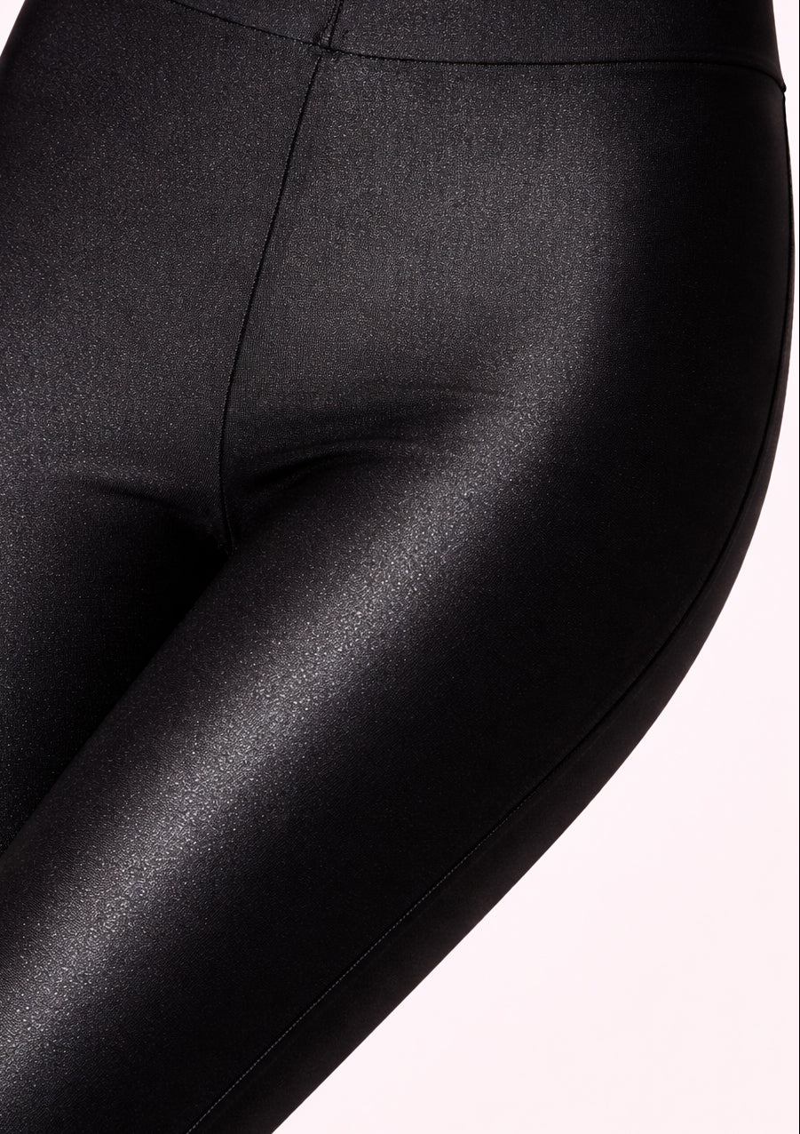 Close-up of black leggings on a white background