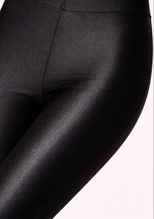 Close-up of black leggings on a white background