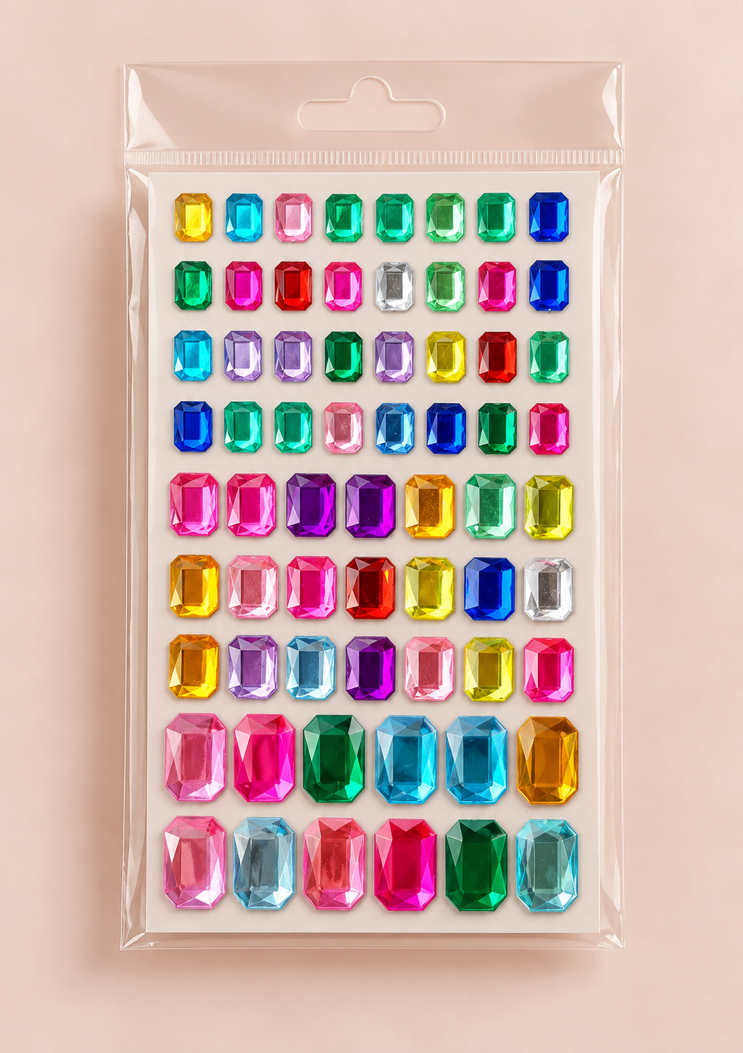A clear plastic package containing rows of colorful faux gem stickers on a soft pink background.