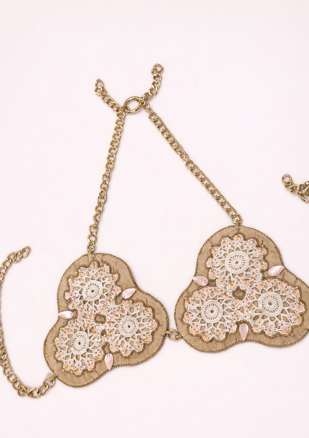 Decorative lace bralette with floral patterns on a white background
