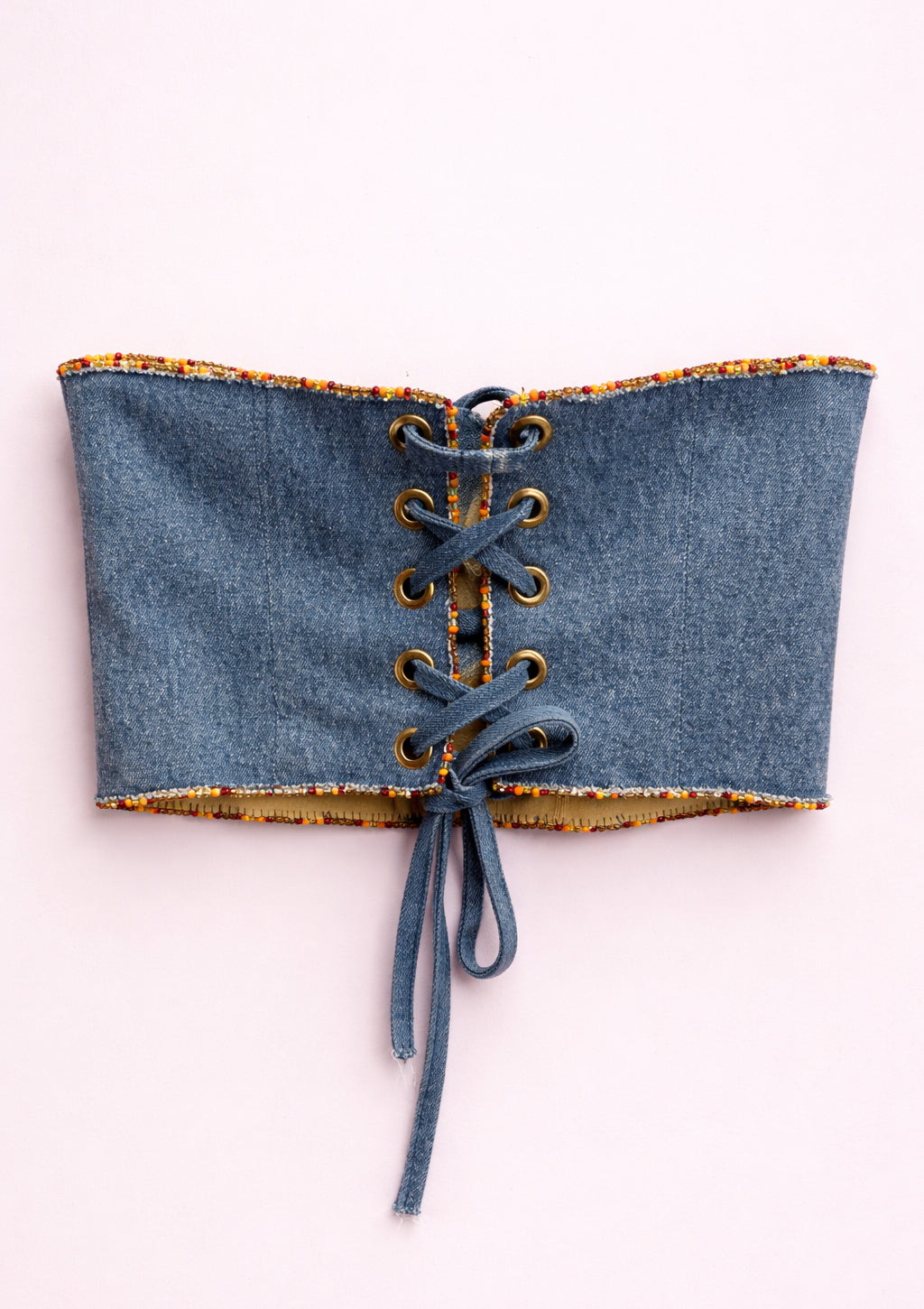 Denim corset with lace-up front on a white background
