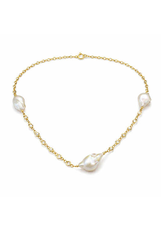 Gold chain necklace with white pearls on a white background