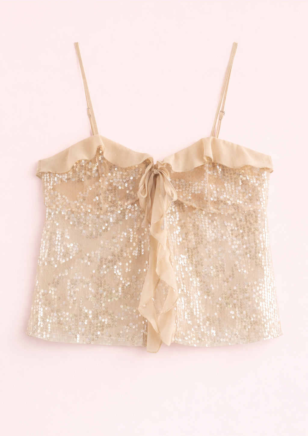 Gold sequin top with a bow on a white background