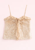 Gold sequin top with a bow on a white background