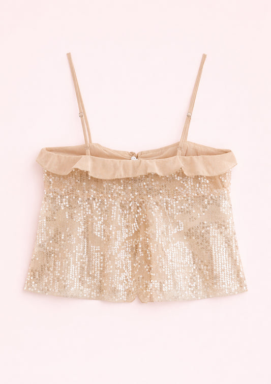 Gold sequin top with thin straps on a light pink background