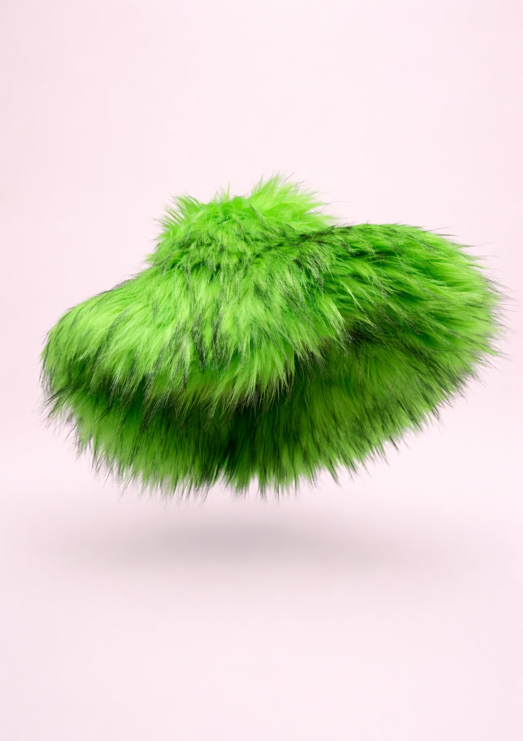 Green fluffy hat on a light pink background