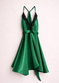 Load image into Gallery viewer, Green satin dress with black lace details on a light pink background
