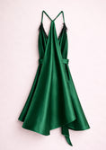 Load image into Gallery viewer, Green satin dress with thin straps on a light pink background
