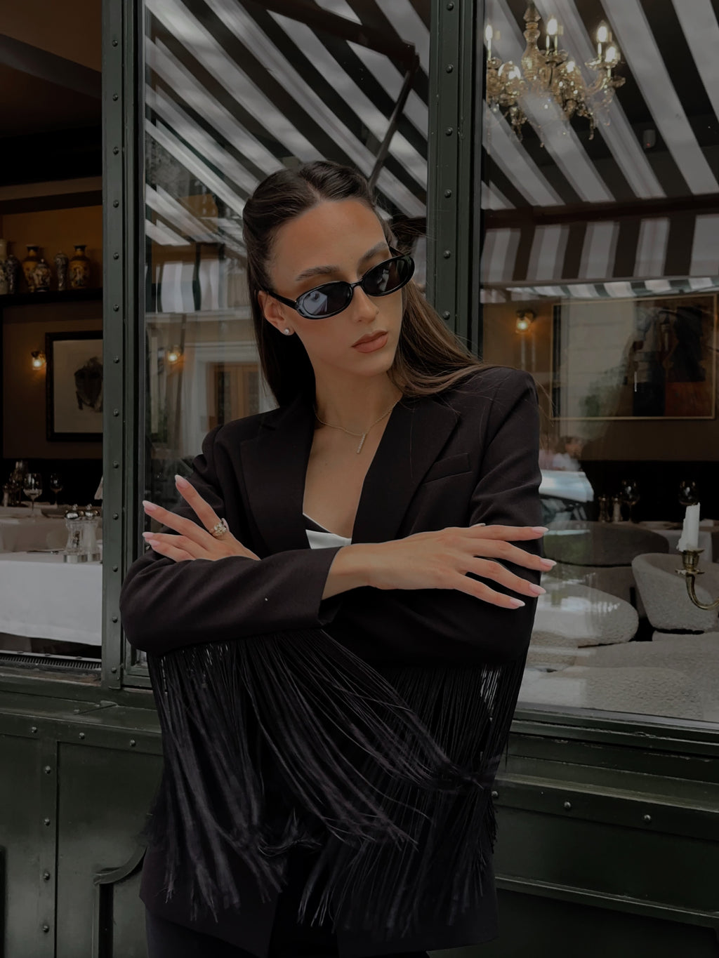 Woman wearing sunglasses in a stylish interior setting