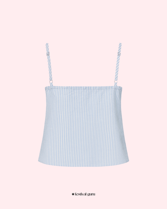 Light blue striped camisole with thin straps on a pink background