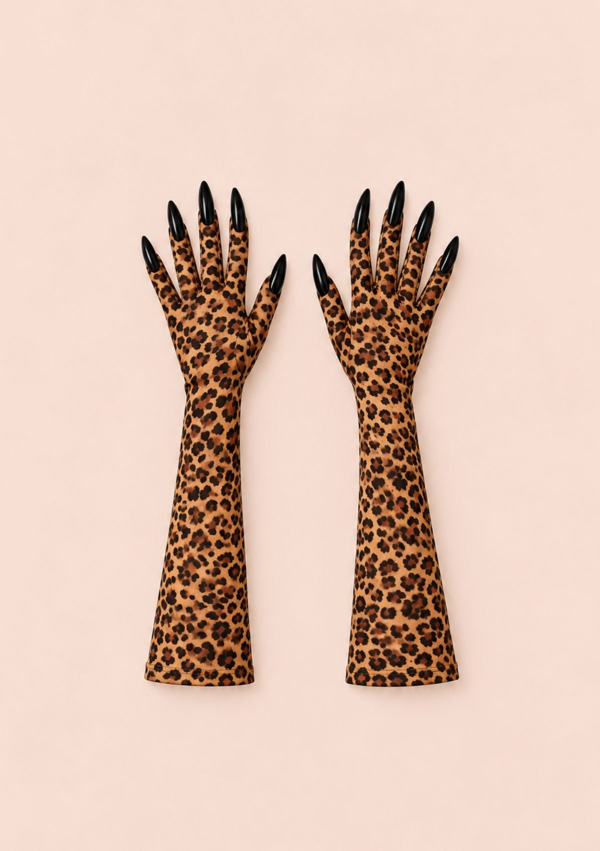 - Long leopard print gloves with decorative black claw nails on a pale pink background.